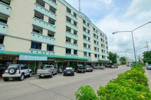 a large white building with cars parked in front of it at BJ Boutique in Rayong