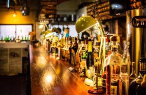 a bar with a lot of bottles of alcohol at 高松guesthouseOLD in Takamatsu