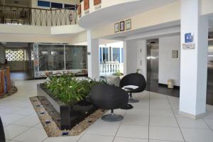 a lobby with two chairs and a table in a building at B12 Cowrie Beach Studio Apartment in Bamburi