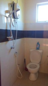 a bathroom with a toilet and a shower in it at Homestay Sri Uda A in Alor Setar