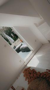 a room with a ceiling with a window and chairs at Rez chaussée transformé en t4 au 114 Avenue de juvisy cottages in Juvisy-sur-Orge