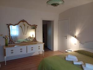 a bedroom with a dresser with a mirror on it at Violetta in Minerbio