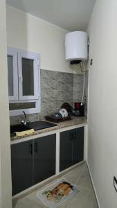 a kitchen with a sink and a counter top at Studio Bayen in Douz +8 photos
