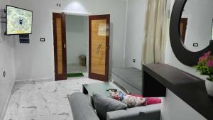 a living room with a couch and a table and a mirror at Studio Bayen in Douz