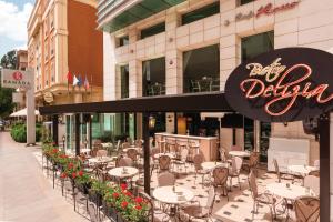 a restaurant with tables and chairs in front of a building at Ramada by Wyndham Ankara in Ankara