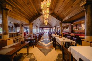 a restaurant with tables and chairs and a large ceiling at Sand Sea Resort Railay Beach in Railay Beach