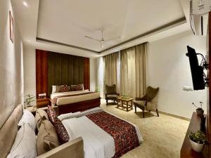 a hotel room with a bed and a television at Vyom Boutique Hotel by Aramah in Rishīkesh +42 photos