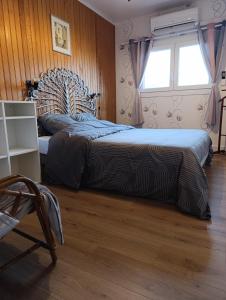 a bedroom with two beds and a window at Le Chalet des Masnils in Grosmagny
