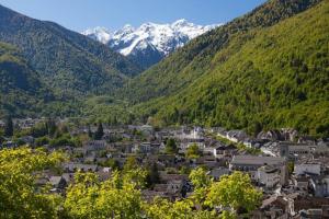a town in the middle of a valley with mountains at Aparthotel Le Petit Train in Luchon