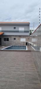 a building with a swimming pool in front of it at Rancho Duarte in Itanhaém +10 photos