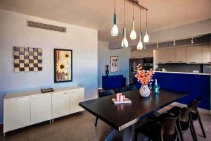 a kitchen and dining room with a table and chairs at Centrally located in Gaios