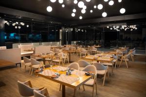 a dining room with wooden tables and chairs at Royal Avenue Kandy in Kandy