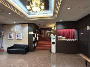 a lobby with a chandelier and aasteryasteryasteryasteryasteryasteryastery at Pioland Hotel in Saitama