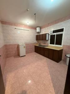 a large kitchen with a refrigerator in a room at مساكن المبيت 5 new in Abha
