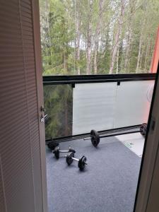 a room with a window with weights on the floor at Prince Palace in Vantaa