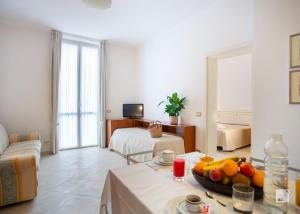 a living room with a table with a bowl of fruit at Genovese Villa Elena Residence in Varazze