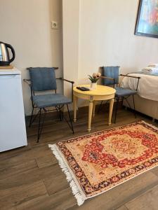 a room with two chairs and a table and a bed at Bosphorus Bridge in Istanbul