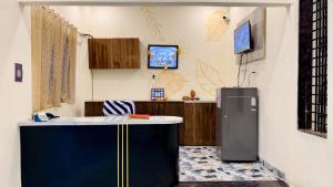 a kitchen with a blue island in a room at Hotel Parth Inn in Indore