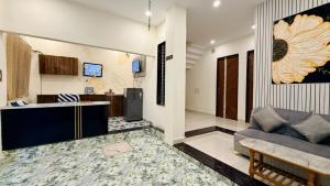 a living room with a couch and a table at Hotel Parth Inn in Indore +8 photos