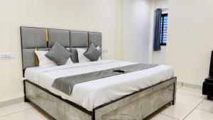 a bedroom with a large bed in a room at Hotel Parth Inn in Indore
