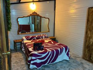 a room with a bed with a mirror on it at Cabaña rural con piscina privada in Orihuela