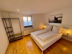 a bedroom with a bed with two lamps and a window at Lichtblick Dähre in Dähre +8 photos