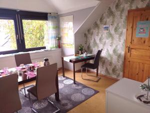 a dining room with a table and chairs at Gästehaus AM HERMANN in Hörstel +6 photos