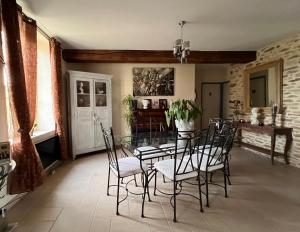 a dining room with a glass table and chairs at CHARM & FOLIe in Praslin