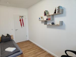a room with a bed and shelves on the wall at Cosy Place for one/two in Berlin
