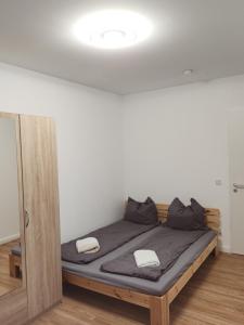 a bed with two pillows on it in a room at Cosy Place for one/two in Berlin