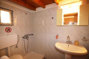a bathroom with a shower and a sink at Katina Balos Rooms-Studios in Koumeika
