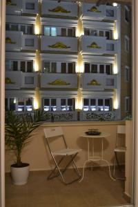a room with a table and chairs in front of a building at Lazarus Apartment in Skopje
