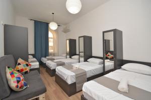 a group of beds in a room with mirrors at Wanderlust Guest House Prime Location in Yerevan