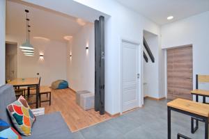 a living room with a door and a dining room at Wanderlust Guest House Prime Location in Yerevan +40 photos