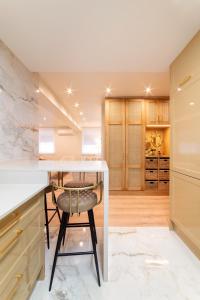 a kitchen with a white counter and a stool at Cangas de Onís CENTRO in Cangas de Onís +23 photos