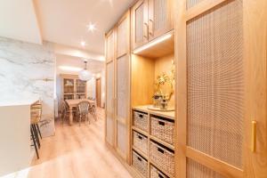 a kitchen with wooden cabinets and a dining room at Cangas de Onís CENTRO in Cangas de Onís