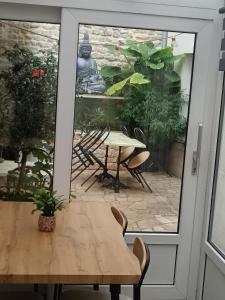 a table and chairs on a patio outside a door at Le Declic in Bayeux