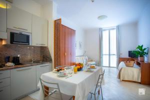 a kitchen with a table with food on it at Genovese Villa Elena Residence in Varazze +13 photos