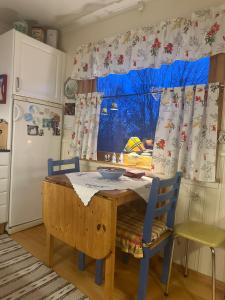 a kitchen with a table and chairs and a window at Holiday home for rent in Lyngen