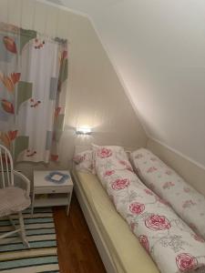a small room with a bed with pillows on it at Holiday home for rent in Lyngen