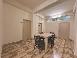 a dining room with a table and chairs at Restel Guest House in Guwahati