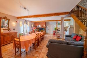 a kitchen and dining room with a table and chairs at La Ferme des Grisettes in Montesquiou