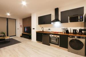 a kitchen with a stove and a dishwasher at Sweet Suites in Valencia