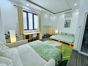 a bedroom with a bed and a desk at Miha Villa 3 - House in Can Tho in Can Tho