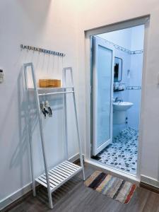 a bathroom with a glass door leading to a sink at Miha Villa 3 - House in Can Tho in Can Tho +19 photos