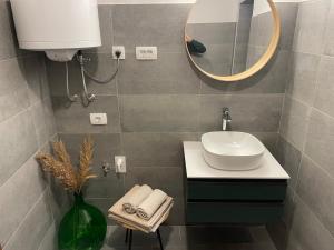 a bathroom with a sink and a mirror at Art apartment Kranj in Kranj +20 photos