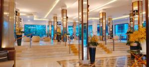 a lobby of a hotel with stairs and chairs at Seapine Beach Golf and Resort Hua Hin in Hua Hin +88 photos
