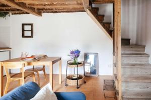 a living room with a wooden table and a table and a dining room at El rinconin del Sueve in San Martín