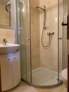a bathroom with a shower and a sink at Penzión - Tempo in Kremnica +36 photos
