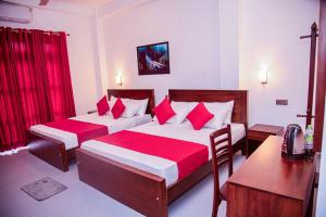 a bedroom with two beds with red pillows at Scenic View - Ella in Ella